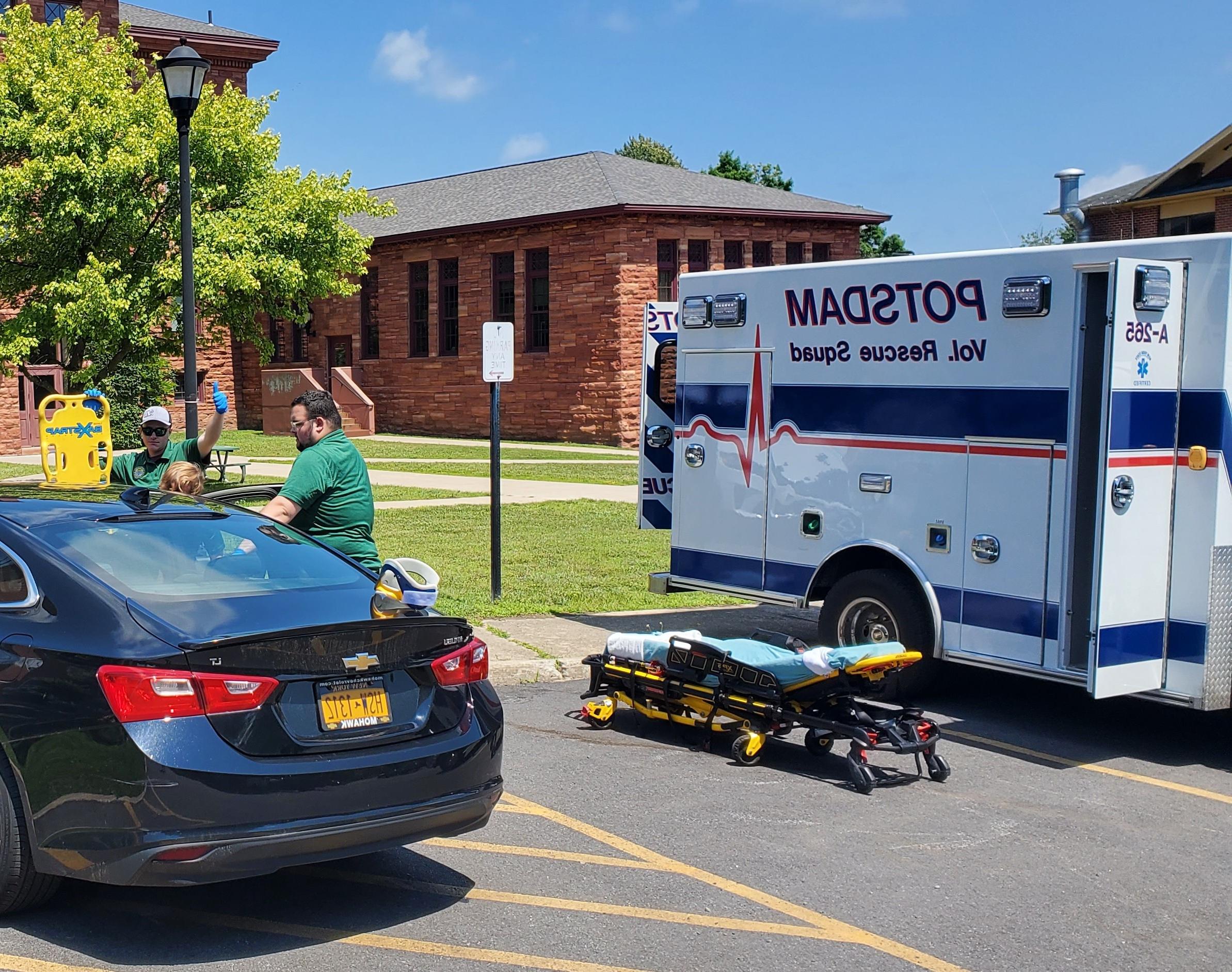 Potsdam rescue ambulance and car parked outside Clarkson's Old Main Hall